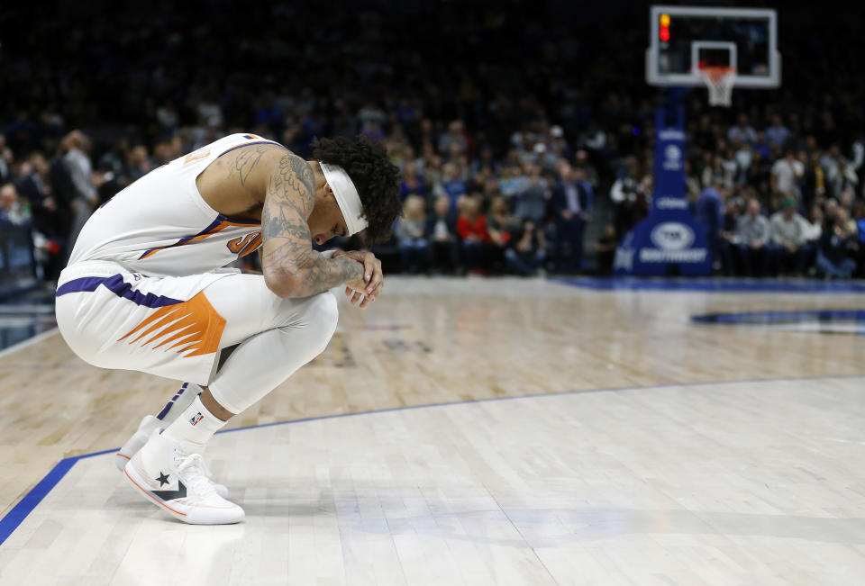 Phoenix Suns forward Kelly Oubre Jr. (3) looks down during a 24 second shot clock violation in honor of Kobe Bryant during an NBA basketball game between the Phoenix Suns and the Dallas Mavericks Tuesday, Jan. 28, 2020, in Dallas. Bryant and his daughter were among nine people killed Sunday in a California helicopter crash. (AP Photo/Ron Jenkins)