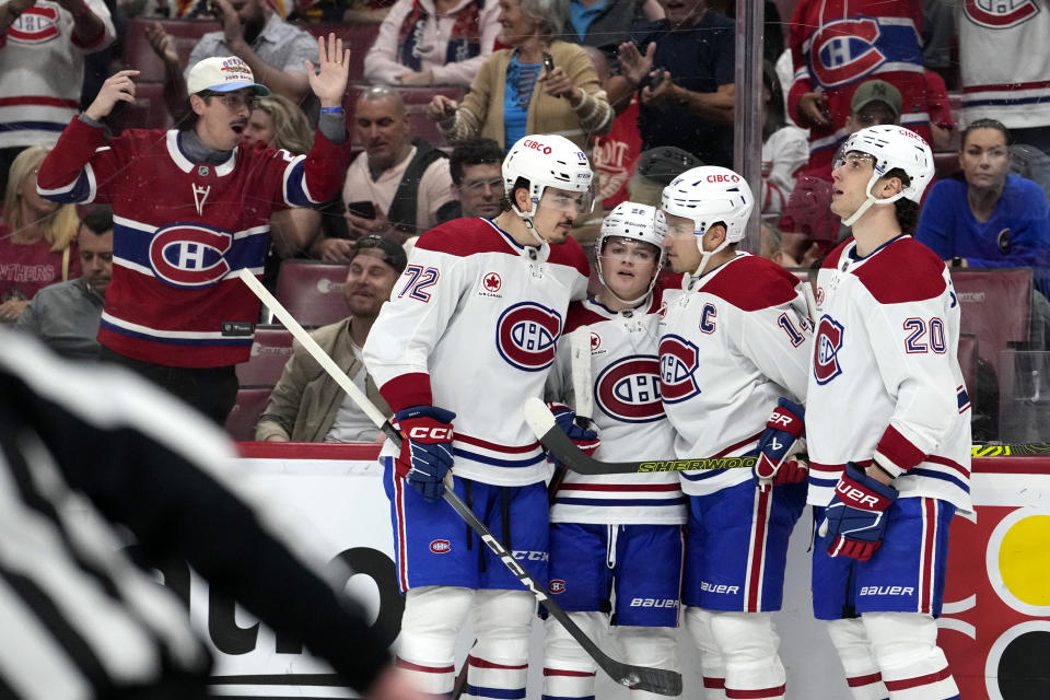 Montreal Canadiens center Nick Suzuki, second from right, is congratulated for his goal against the Florida Panthers during the first period of an NHL hockey game Thursday, Feb. 29, 2024, in Sunrise, Fla. (AP Photo/Lynne Sladky)