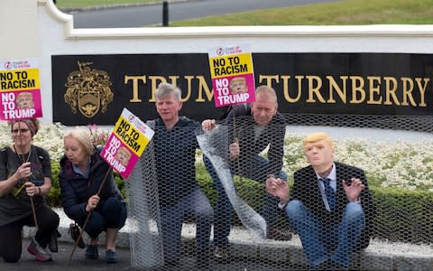 Activists from Stand Up to Racism Scotland (SUTR) stage a protest at the Trump Turnberry resort in South Ayrshire, ahead of the US president's arrival in the UK - Credit: PA