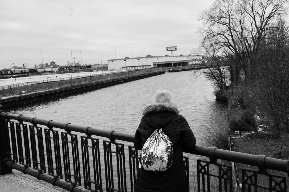 Maria Cinfuentes with her back to the camera near one of Chicago' s shelters. (Sebastian Hidalgo for NBC News)