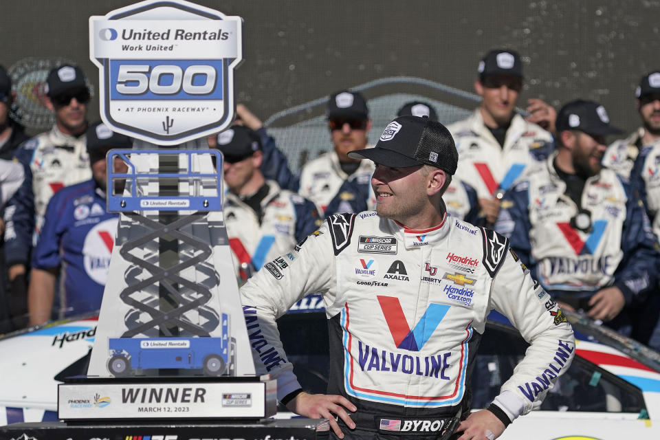 William Byron looks at his trophy after winning a NASCAR Cup Series auto race at Phoenix Raceway, Sunday, March 12, 2023, in Avondale, Ariz. (AP Photo/Darryl Webb)