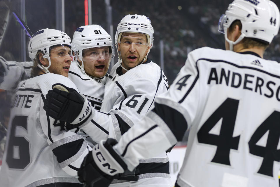 Los Angeles Kings right wing Carl Grundstrom, second from the left, is congratulated by center Blake Lizotte (46), center Trevor Lewis (61) and defenseman Mikey Anderson (44) after scoring a goal against the Minnesota Wild during the first period of an NHL hockey game Thursday, Oct. 19, 2023, in St. Paul, Minn. (AP Photo/Matt Krohn)