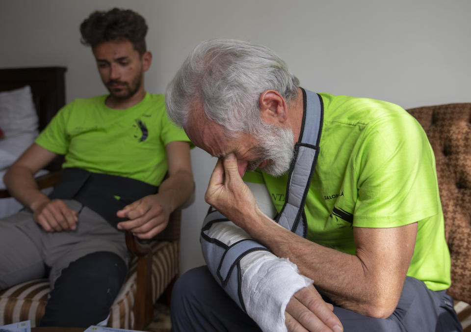 The team leader, Tarcisio Bello, 57, right, breaks in tears while talking about a Pakistani colleague who lost his life during heavy avalanche, in Islamabad, Pakistan, Thursday, June 20, 2019. The renowned Italian mountaineer recalled how helplessly he saw one of his Pakistani colleagues being swept away by an avalanche that struck them at an altitude of around 5,300 meters (17,390 feet) earlier this week. (AP Photo/B.K. Bangash)