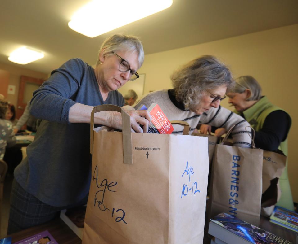 From left, Pat Luczai and Liz Graham, members of the Poughkeepsie Branch of the American Association of University Women bag books sorted by age for their Holiday Helping Hand project, Leading to Reading at the United Methodist Church in Hude Park on November 29, 2023.