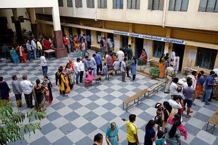 Voters wait in queues to cast their ballot outside a polling station during Karnataka assembly elections in Bengaluru, India, May 12, 2018. REUTERS/Abhishek N. Chinnappa