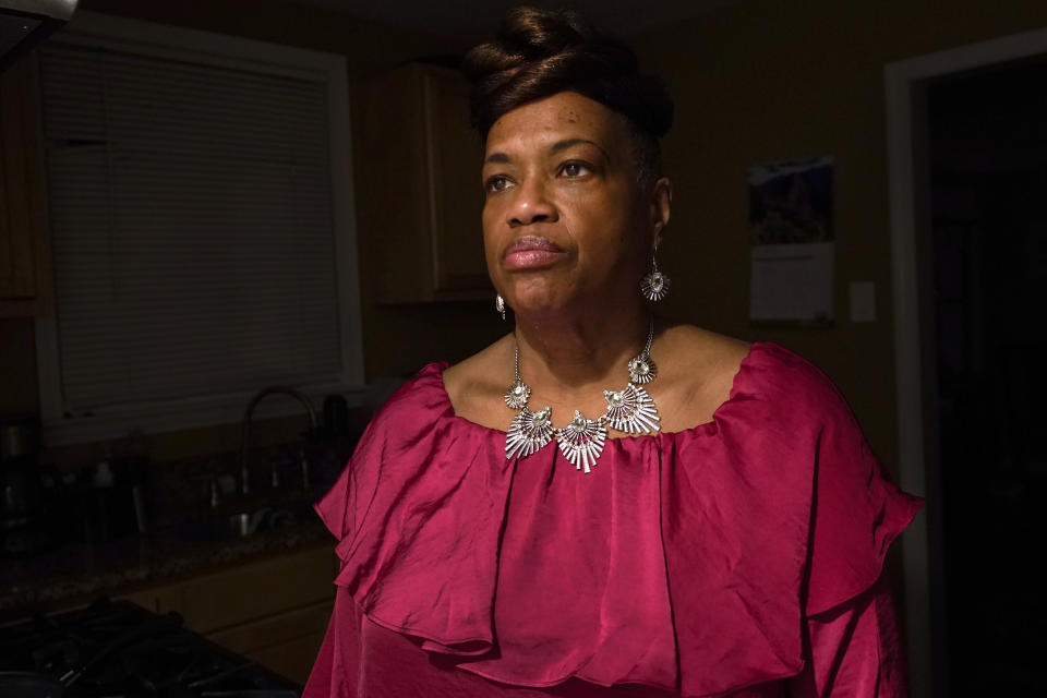 Karla Jefferies stands in her kitchen in Detroit, Friday, March 5, 2021. Jefferies, 64, a retired state worker in Detroit, Michigan, tested positive for COVID-19 in March 2020 and has been bothered by puzzling symptoms ever since. First it was fatigue, fever, and no taste or smell. Then came brain fog, insomnia, a nagging smell of something burning that only recently disappeared, and intermittent ringing in her ears. Now she can't hear out of her left ear. (AP Photo/Paul Sancya)