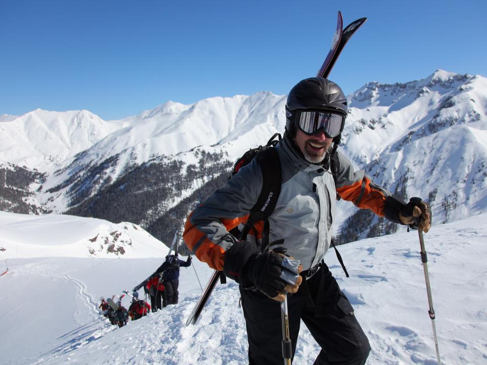 Hiking up a snowy mountain skiing