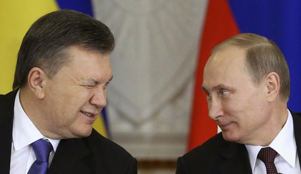 Ukrainian President Yanukovich gives a wink to his Russian counterpart Putin during a signing ceremony after a meeting of the Russian-Ukrainian Interstate Commission at the Kremlin in Moscow