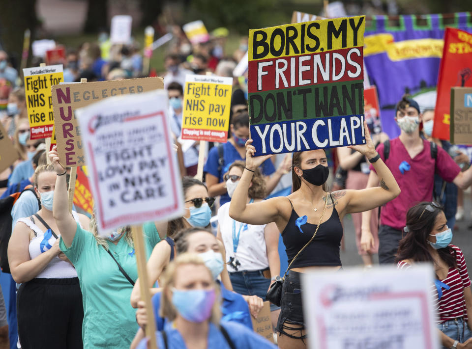 National Health Service (NHS) workers march from St. James' Park to Downing Street, London, Saturday Aug. 8, 2020, as part of a national protest over pay. Nationwide protests on Saturday are calling for government to address what they claim is many years of reduced wages, and are calling for a voice in plans for public sector pay increases. (Dominic Lipinski/PA via AP)