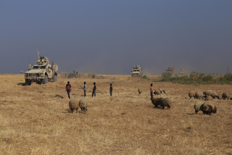 A Turkish armored vehicle patrols with American forces, as they conduct their second joint ground patrol in the so-called "safe zone" on the Syrian side of the border with Turkey, in Rahaf village, near the town of Tal Abyad, northeastern Syria, Tuesday, Sept. 24, 2019. The patrols are part of a deal reached between Turkey and the United States to ease tensions between the allies over the presence of U.S.-backed Syrian Kurdish fighters in the area. (AP Photo/Baderkhan Ahmad)