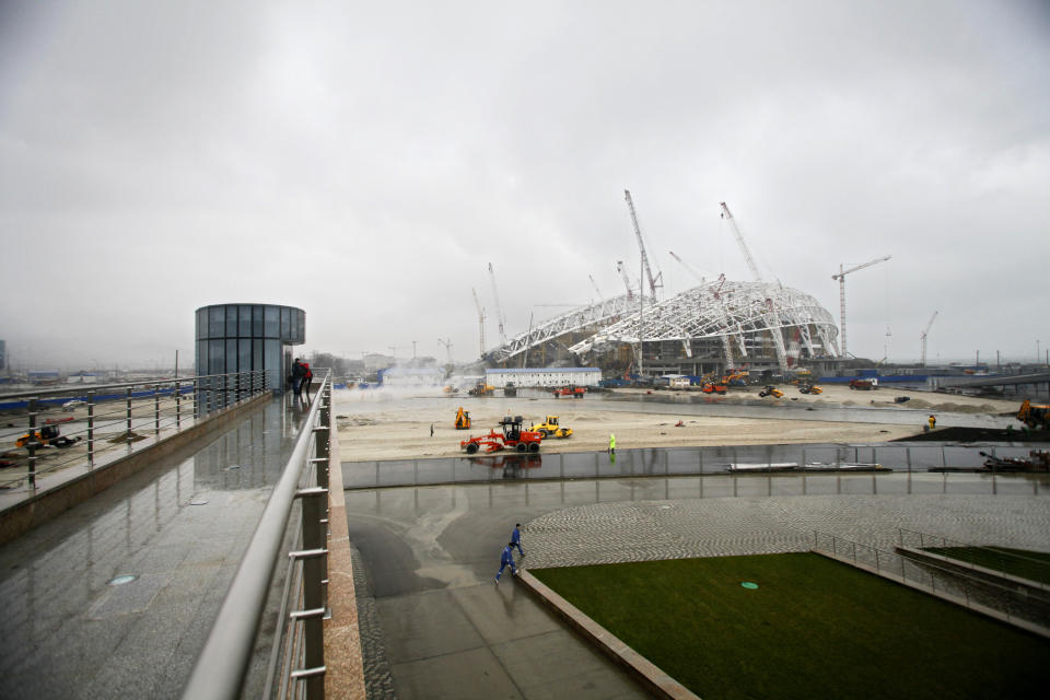 FOR STORY RUSSIA SOCHI YEAR TO GO - In this photo dated Wednesday, Jan. 30, 2013, The main Olympic stadium is seen under construction at the Russian Black Sea resort of Sochi, with just one year till the opening ceremony of the winter Olympic 2014 Sochi Games. The Black Sea resort of Sochi is a vast construction site sprawling for nearly 40 kilometers (25 miles) along the coast and 50 kilometers (30 miles) up into the mountains, with no escape from the clang and clatter of the construction works, the drilling, jack-hammering and mixing of cement. (AP Photo/Igor Yakunin)