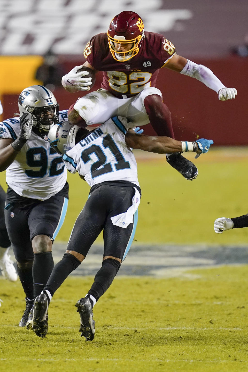 Washington Football Team tight end Logan Thomas (82) leaps over Carolina Panthers outside linebacker Jeremy Chinn (21) for a first down during the second half of an NFL football game Sunday, Dec. 27, 2020, in Landover, Md. Carolina won 20-13. (AP Photo/Carolyn Kaster)