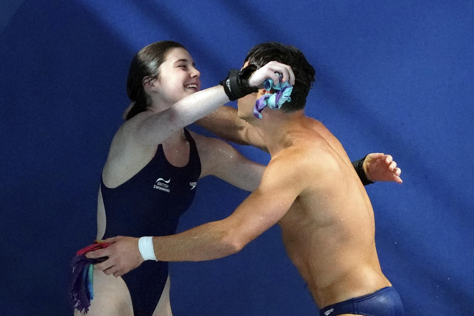 Andrea Spendolini Sirieix and Thomas Daley of Great Britain embrace after their dive during the mixed synchronized diving 3 and 10m platform final at the World Aquatics Championships in Doha, Qatar, Friday, Feb. 2, 2024. (AP Photo/Hassan Ammar)