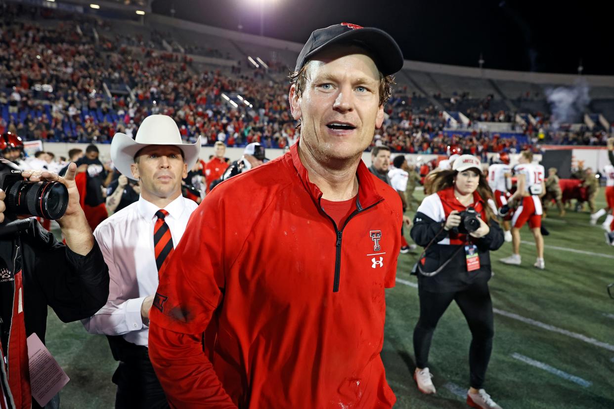 Texas Tech interim coach Sonny Cumbie runs onto the field after the Liberty Bowl NCAA college football game on Tuesday, Dec. 28, 2021, in Memphis, Tenn.