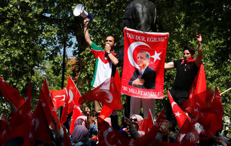 Demonstrators wave flags outside Downing Street ahead of the visit by Turkey's President Recep Tayyip Erdogan, in London, Britain, May 15, 2018. REUTERS/Phil Noble