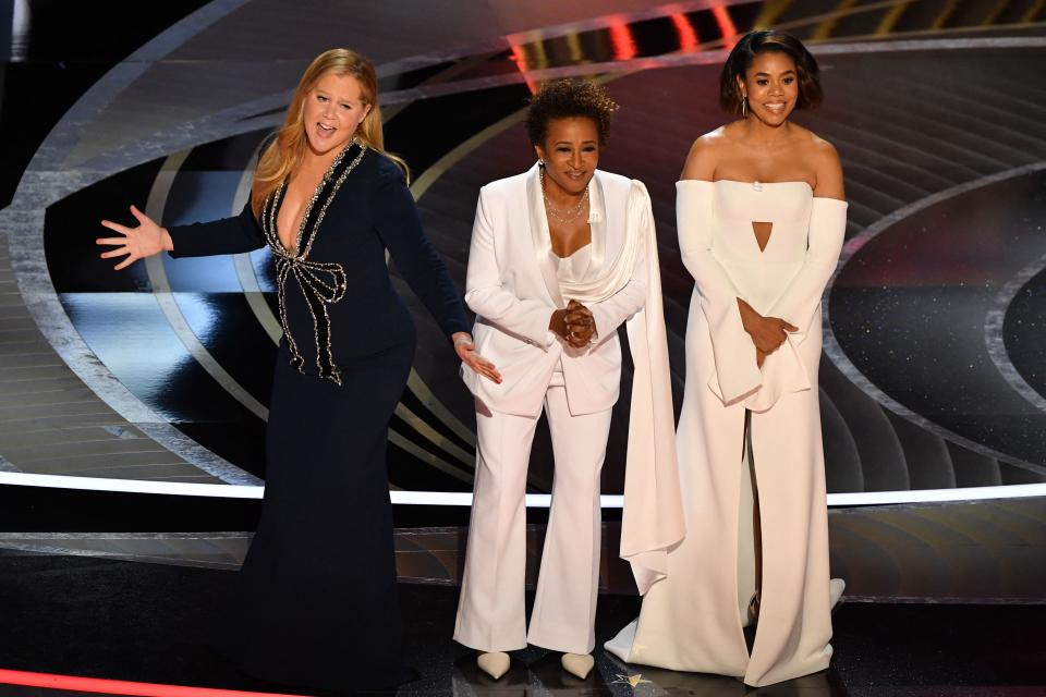 US actress and comedian Amy Schumer (L), US actress and comedian Wanda Sykes (C) and US actress Regina Hall speak onstage during the 94th Oscars at the Dolby Theatre in Hollywood, California on March 27, 2022. (Photo by Robyn Beck / AFP) (Photo by ROBYN BECK/AFP via Getty Images)