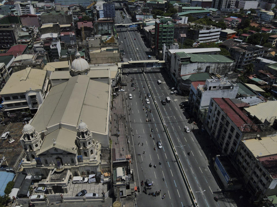 Quiapo church stands beside an almost empty road as the government implements a strict lockdown to prevent the spread of the coronavirus on Good Friday, April 2, 2021 in Manila, Philippines. Filipinos marked Jesus Christ's crucifixion Friday in one of the most solemn holidays in Asia's largest Catholic nation which combined with a weeklong coronavirus lockdown to empty Manila's streets of crowds and heavy traffic jams. Major highways and roads were eerily quiet on Good Friday and churches were deserted too after religious gatherings were prohibited in metropolitan Manila and four outlying provinces. (AP Photo/Aaron Favila)