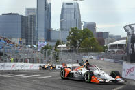 Christian Lundgaard (30) comes through a turn during the Music City Grand Prix auto race Sunday, Aug. 7, 2022, in Nashville, Tenn. (AP Photo/Mark Humphrey)