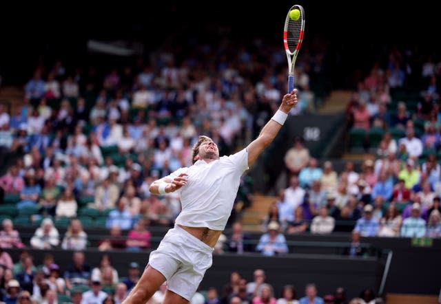 Cameron Norrie stretches to hit an overhead shot