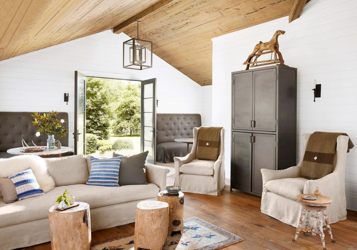 family room with neutral linen upholstery and big gray cabinet