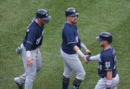 Jul 14, 2018; Pittsburgh, PA, USA; Milwaukee Brewers third baseman Travis Shaw (21) greets right fielder Hernan Perez (middle) and catcher Jacob Nottingham (26) after both players scored runs against the Pittsburgh Pirates during the ninth inning at PNC Park. Pittsburgh won 6-2. Mandatory Credit: Charles LeClaire-USA TODAY Sports