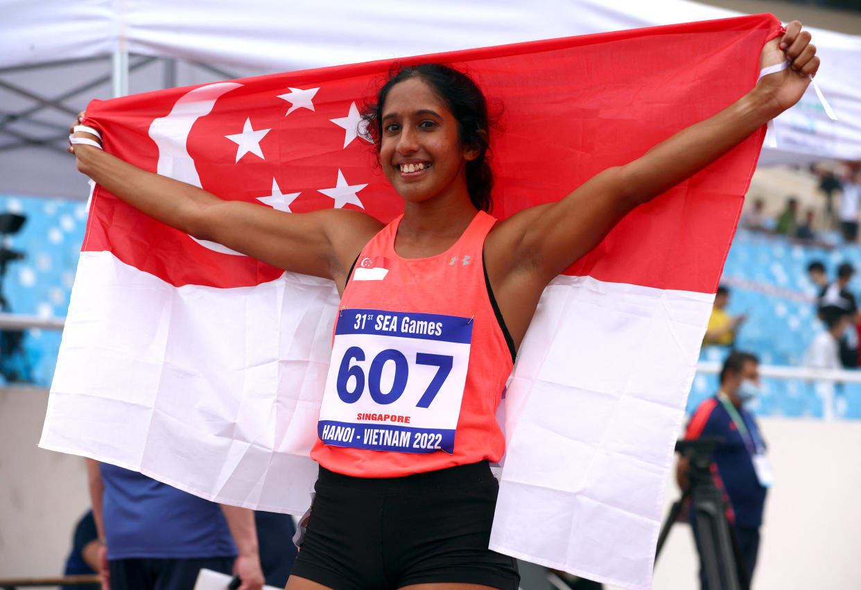 Singapore sprinter Shanti Pereira celebrates winning the women's 200m final at the Hanoi SEA Games. (PHOTO: Reuters/Athit Perawongmetha)