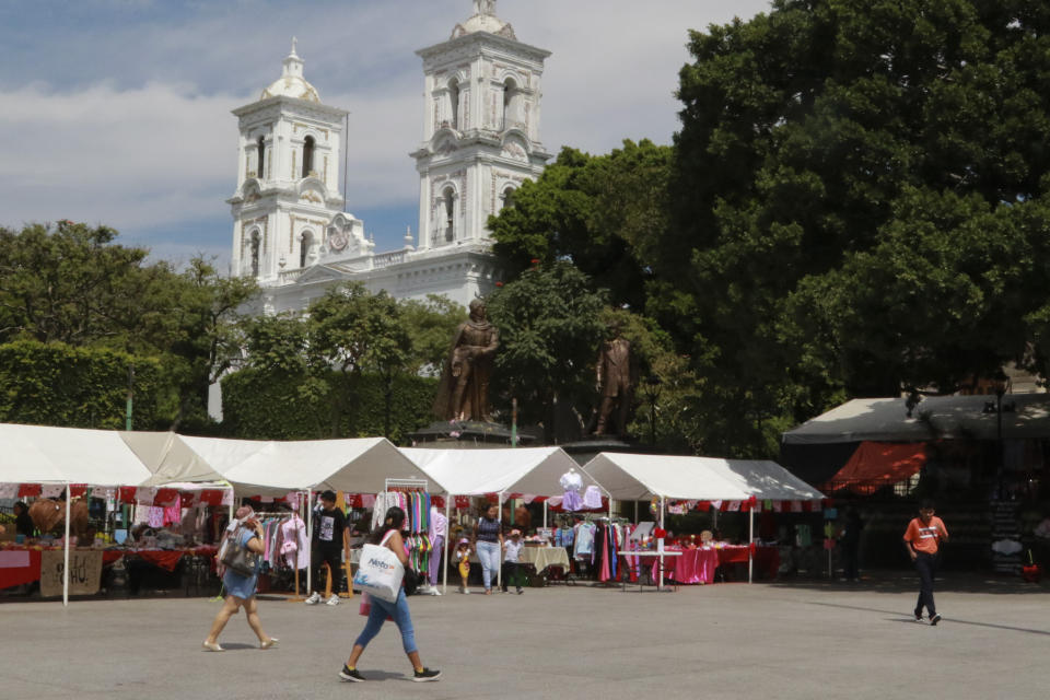 People walk near the Cathedral in Chilpancingo, Mexico, Thursday, Feb. 15, 2024. Four Roman Catholic bishops met with Mexican drug cartel bosses in a bid to negotiate a possible peace accord, according to the Bishop of Chilpancingo-Chilapa, José de Jesús González Hernández. (AP Photo/Alejandrino Gonzalez)