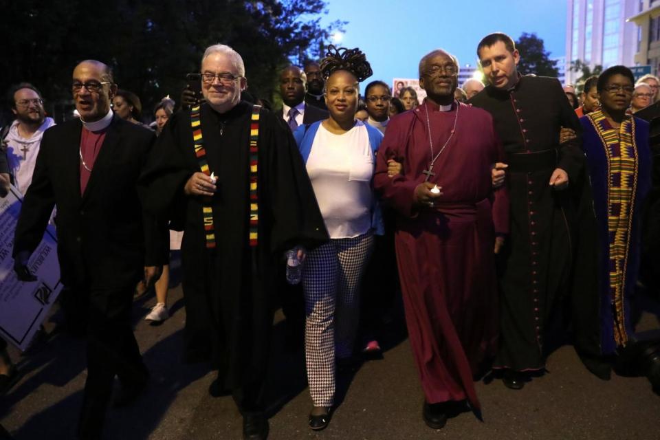 Bishop Curry leads fellow clergy on the march on the White House (REUTERS)