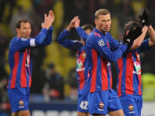 Players of CSKA Moscow celebrate after scoring against Real Madrid during their round of 16, first leg UEFA Champions League match in Moscow. The game ended 1-1