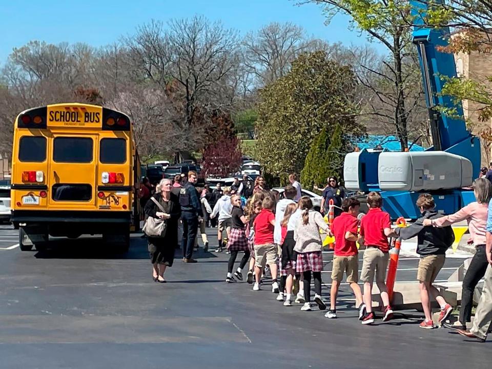 Children from The Covenant School, a private Christian school in Nashville, Tenn., hold hands as they are taken to a reunification site at the Woodmont Baptist Church after a deadly shooting at their school on Monday, March 27, 2023.