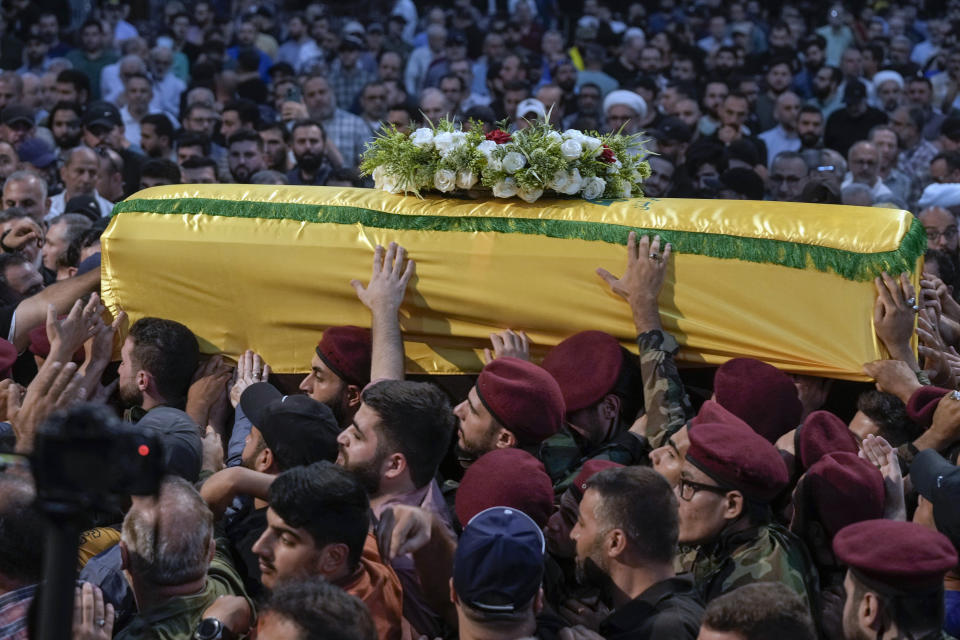 Hezbollah fighters carry the coffin of their comrade, senior commander Mohammad Naameh Nasser, who was killed by an Israeli airstrike that hit his car in the southern costal town of Tyre, during his funeral procession in the southern suburbs of Beirut, Lebanon, Thursday, July 4, 2024. (AP Photo/Bilal Hussein)