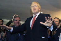 Britain's Prime Minister Boris Johnson gestures as he speaks to supporters on a visit to meet newly elected Conservative party MP for Sedgefield, Paul Howell, at Sedgefield Cricket Club in County Durham, north east England, Saturday Dec. 14, 2019, following his Conservative party's general election victory. Johnson called on Britons to put years of bitter divisions over the country's EU membership behind them as he vowed to use his resounding election victory to finally deliver Brexit. (Lindsey Parnaby/Pool via AP)