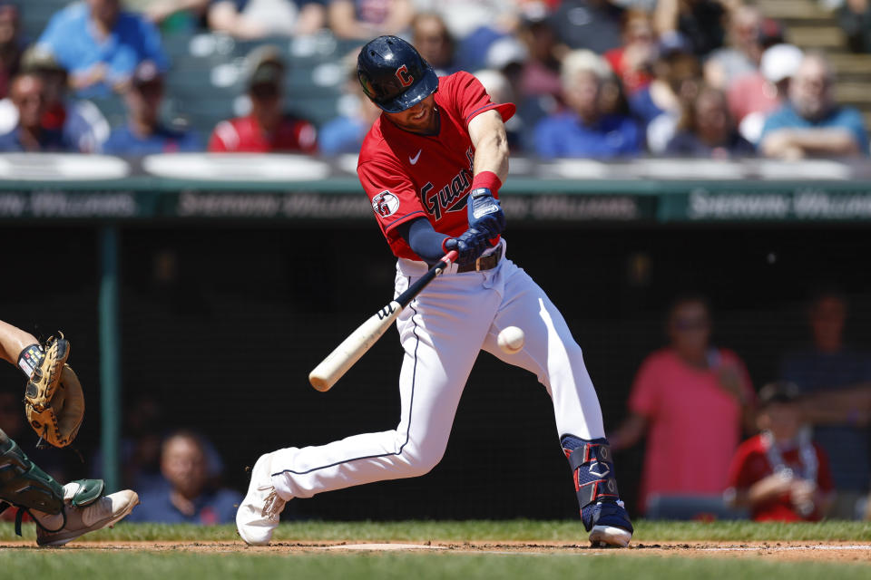 Cleveland Guardians' Owen Miller hits an RBI single against the Oakland Athletics during the first inning of a baseball game, Sunday, June 12, 2022, in Cleveland. (AP Photo/Ron Schwane)