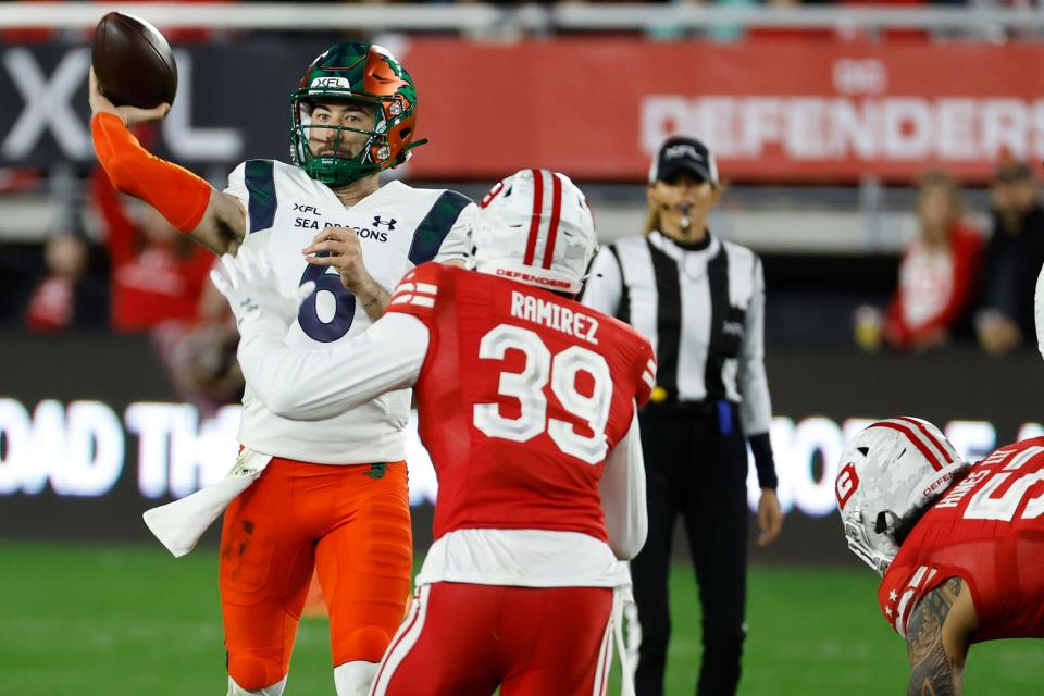 Feb. 19: Seattle Sea Dragons quarterback Ben DiNucci (6) passes the ball as D.C. Defenders safety Ramirez Santos defends.