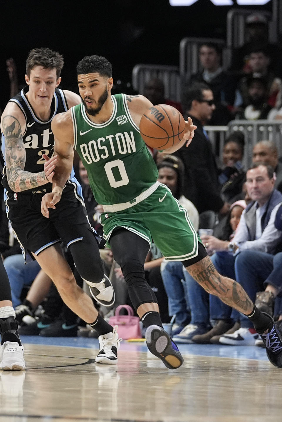 Boston Celtics forward Jayson Tatum (0) drives against Atlanta Hawks guard Vit Krejci (27) during the first half of an NBA basketball game Monday, March 25, 2024, in Atlanta. (AP Photo/John Bazemore)