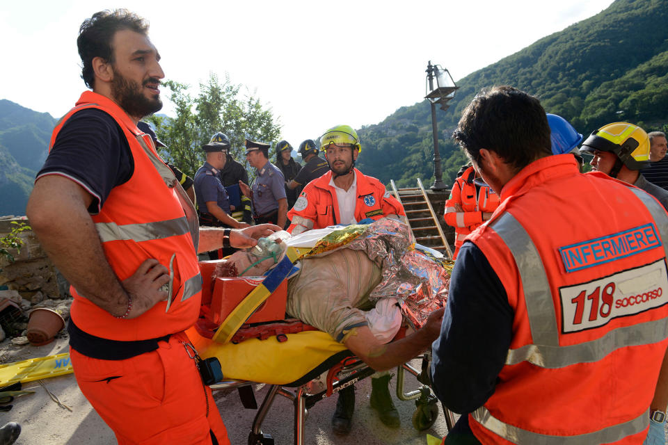 <p>A man is treated by medical personnel after being rescued following an earthquake in Arquata del Tronto, Italy, Wednesday, Aug. 24, 2016. (AP Photo/Sandro Perozzi) </p>