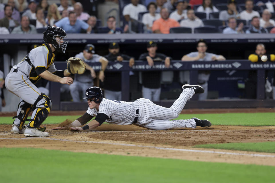 New York Yankees' Harrison Bader scores ahead of the throw to Pittsburgh Pirates catcher Jason Delay during the fifth inning of a baseball game Tuesday, Sept. 20, 2022, in New York. (AP Photo/Jessie Alcheh)