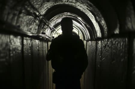 A Palestinian fighter from the Izz el-Deen al-Qassam Brigades, the armed wing of the Hamas movement, is seen inside an underground tunnel in Gaza August 18, 2014. REUTERS/Mohammed Salem