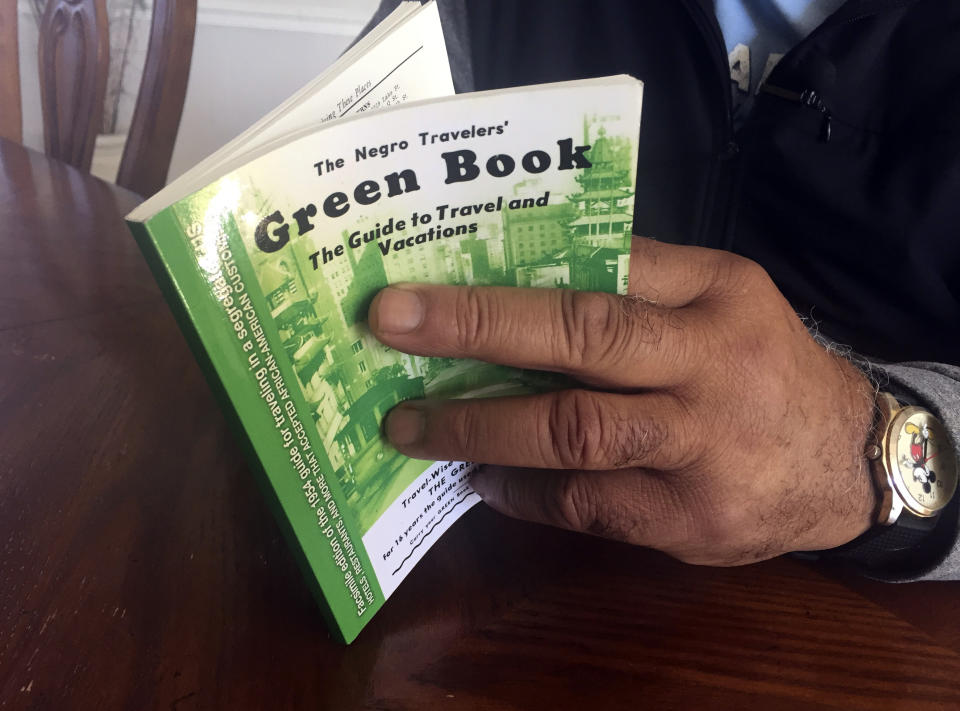 In this Jan. 31, 2019 photo, Charles Becknell, Sr., 77, holds a copy of 1954 the edition of "The Negro Motorist Green Book" at his home in Rio Rancho, N.M. The Oscar-nominated interracial road trip movie "Green Book" has spurred interest in the 20th Century guidebook that helped black travelers navigate segregated America. (AP Photo/Russell Contreras)