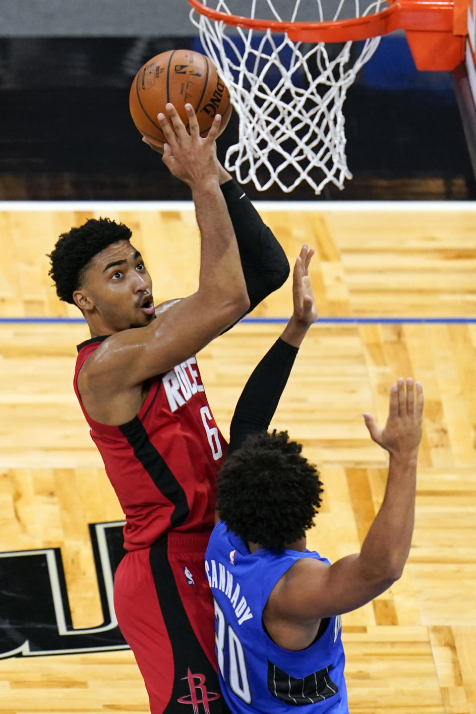 Houston Rockets forward KJ Martin, left, takes a shot over Orlando Magic guard Devin Cannady during the first half of an NBA basketball game, Sunday, April 18, 2021, in Orlando, Fla. (AP Photo/John Raoux)