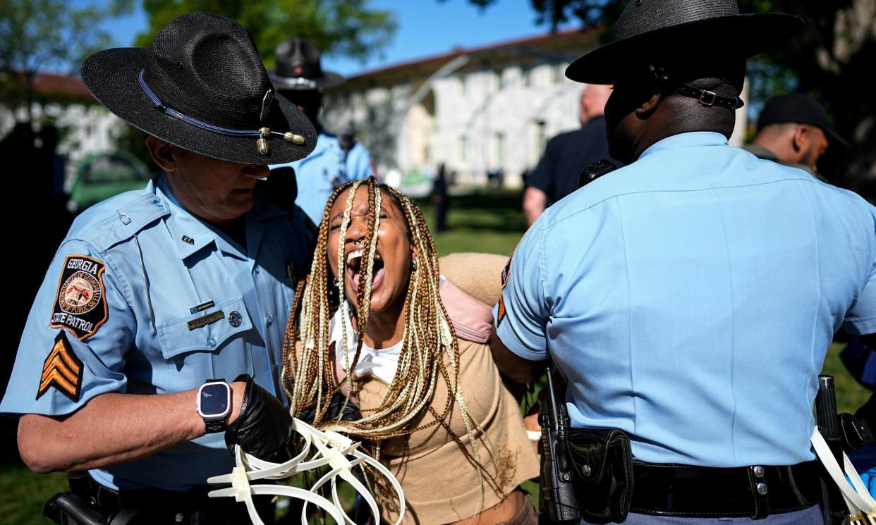 <span>Georgia state patrol officers detain a demonstrator at Emory University on 25 April 2024.</span><span>Photograph: Mike Stewart/AP</span>