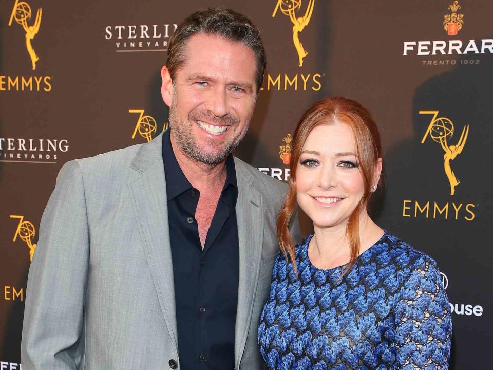 <p>JB Lacroix/WireImage</p> Alexis Denisof and Alyson Hannigan at the Television Academy