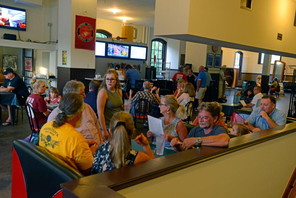 Customers enjoy a beer and a meal Saturday, August 19, 2017 at Brew Angels brew pub in the old Milton post office.