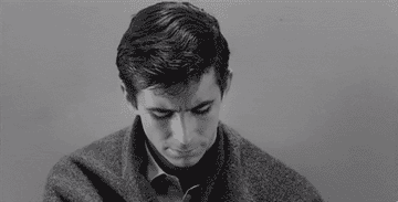 Norman Bates looking up at the camera in the final shot of "Psycho"