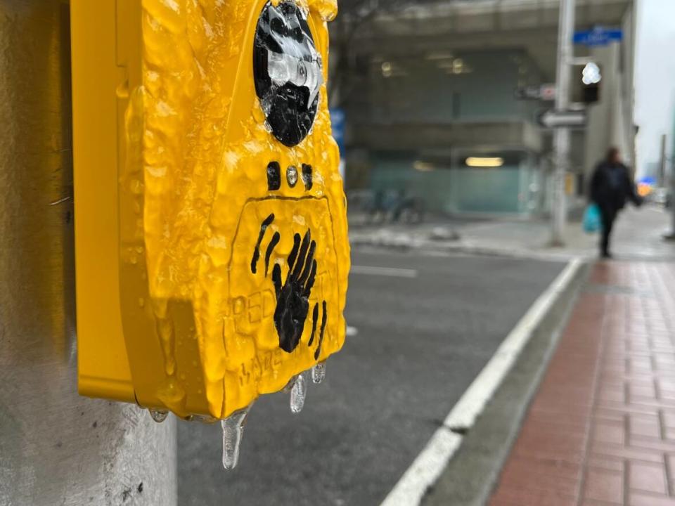 Ice coats a crosswalk sensor in Ottawa on Jan. 5, 2023. Environment Canada issued freezing rain warnings for the city the night before and again on Thursday. (Matthew Kupfer/CBC - image credit)