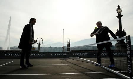 Bjorn Borg of Sweden returns the ball to Switzerland's Roger Federer (L) during a tennis session to promote the Laver Cup tennis tournament on a temporary court on the banks of Lake Geneva in Geneva, Switzerland February 8, 2019. REUTERS/Arnd Wiegmann