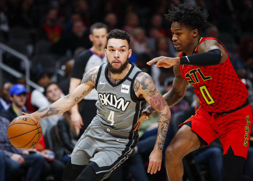 Brooklyn's Chris Chiozza drives to the basket against the Hawks' Brandon Goodwin on Feb. 28 in Atlanta. (Photo by Todd Kirkland/Getty Images)