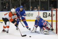 New York Rangers goaltender Jonathan Quick (32) and defenseman Ryan Lindgren (55) defend against Philadelphia Flyers right wing Bobby Brink (10) during the first period of an NHL hockey game Thursday, April 11, 2024, at Madison Square Garden in New York. (AP Photo/Mary Altaffer)