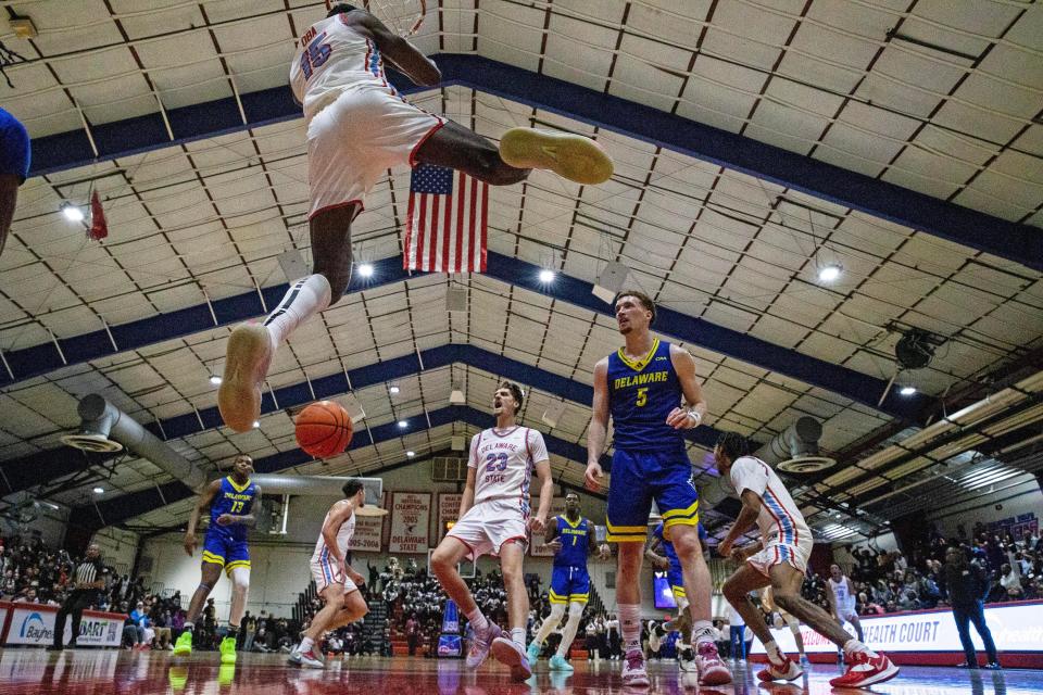 Delaware State University Hornets forward Wesley Oba (15) dunks the ball against the University of Delaware Blue Hens during the annual men's basketball game at DSU's Memorial Hall in Dover, Wednesday, Nov. 15, 2023. The Hens they won 78-67.