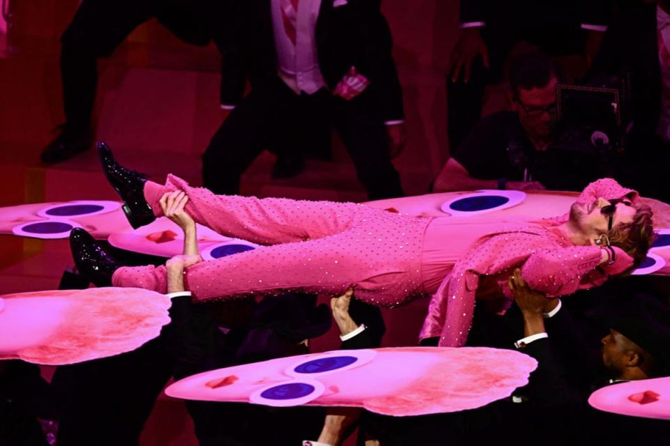 At one point Gosling was surrounded by cut out heads of Barbie dolls (AFP via Getty Images)